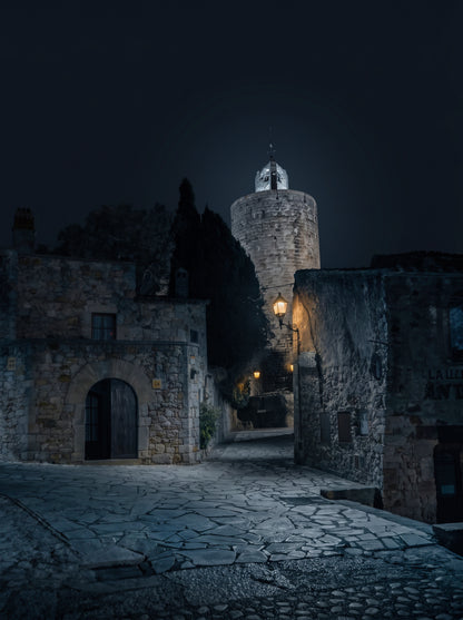 Keeper of Hours — night photograph of the Torre de les Hores in Pals, Girona, under a starry sky. Limited edition fine art print by Marco Zouvek.
